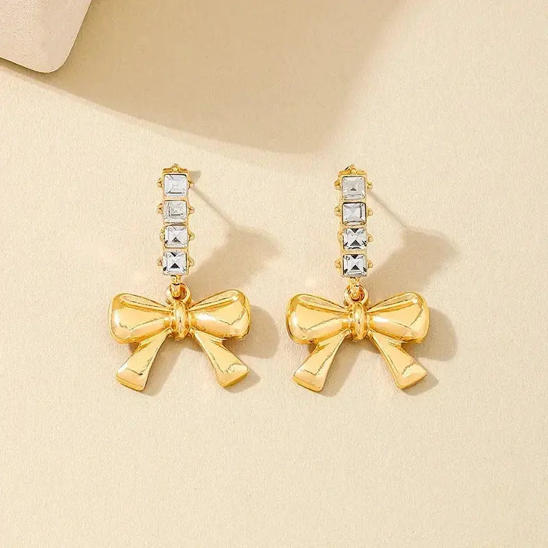Gold-tone bow dangle earrings with clear crystal bars