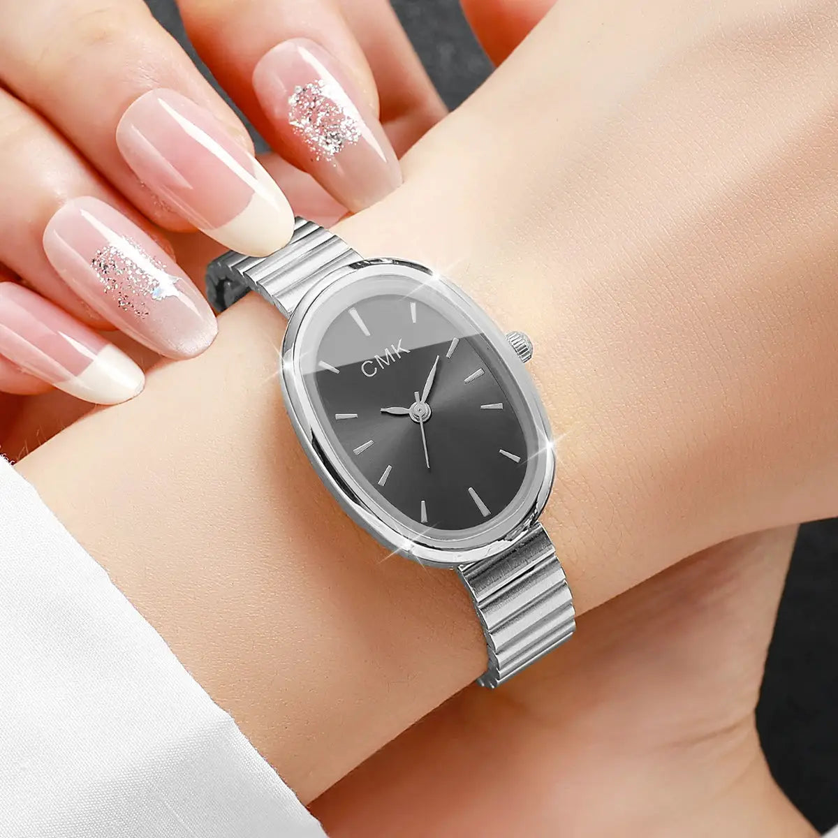 Simples Market CMK women's watch with an oval black dial and slim stainless steel strap