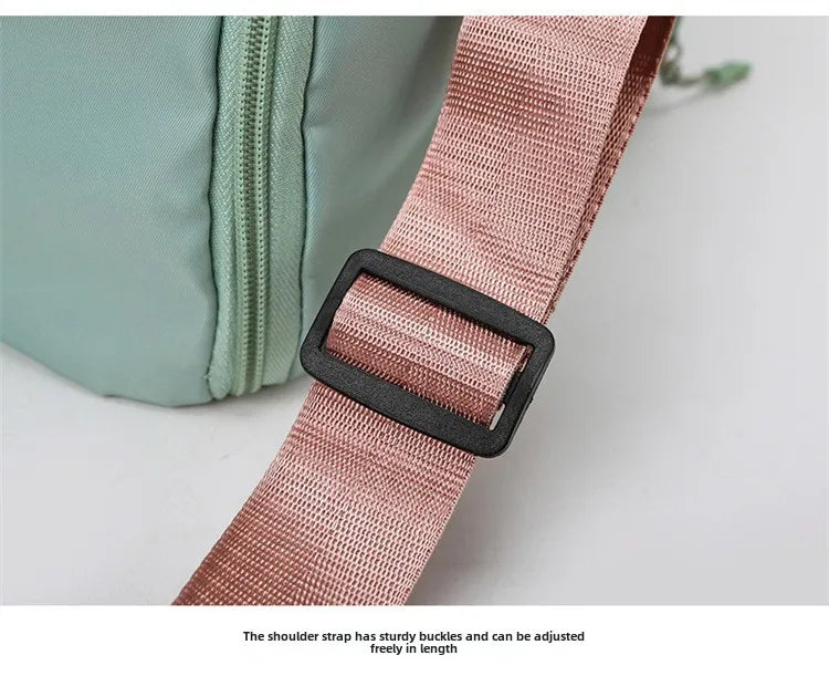 Fitness bag with pink adjustable strap on a mint-green exterior; versatile travel/yoga bag