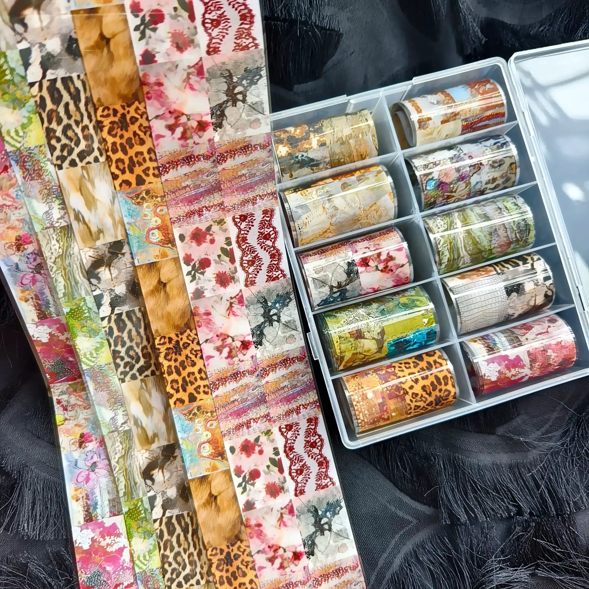 10-roll nail foil set with leopard, floral, and marble patterns in a clear organizer