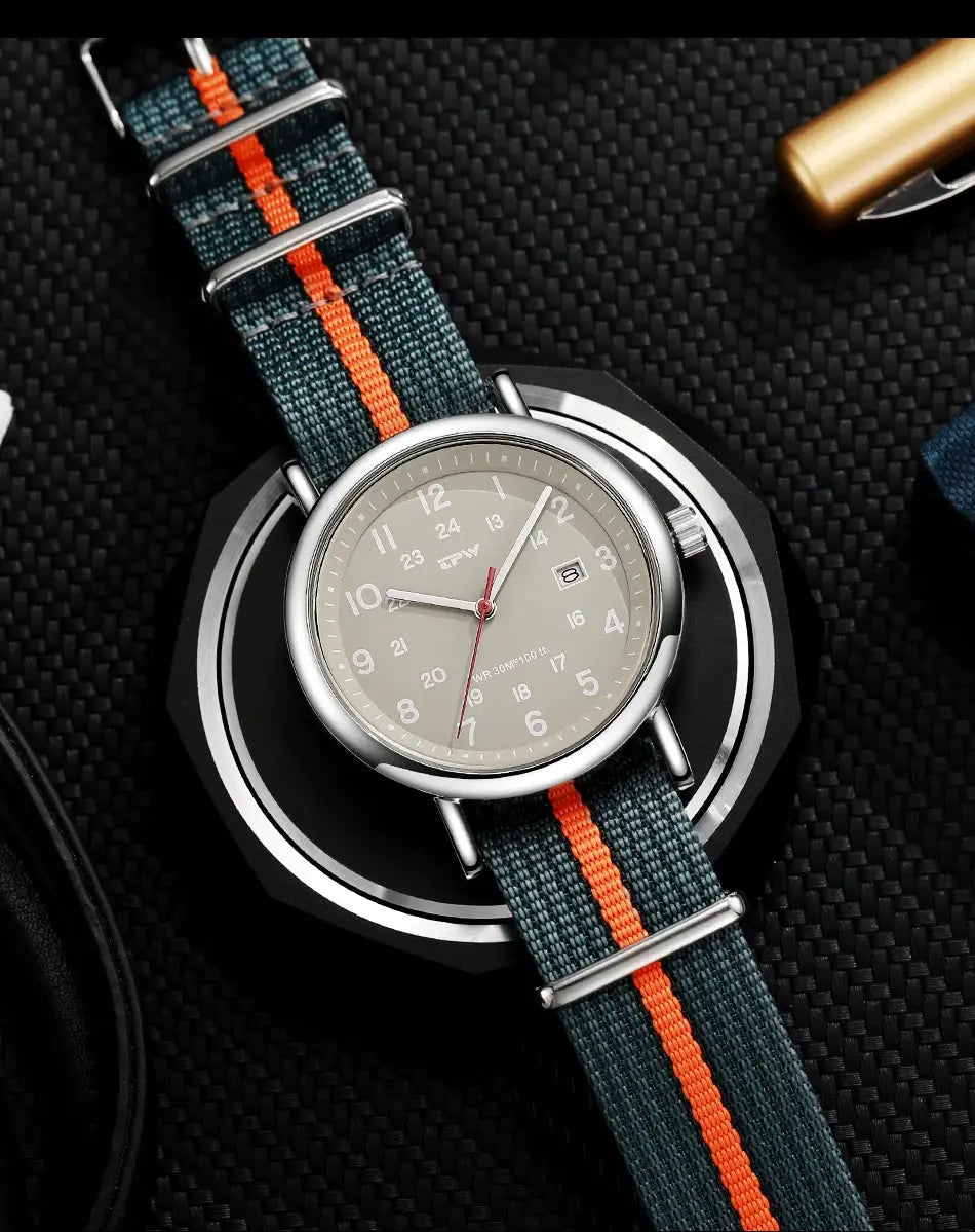 2026 TPW Field Watch with teal fabric strap, orange stripe, khaki dial, 24-hour markings, date window, quartz movement