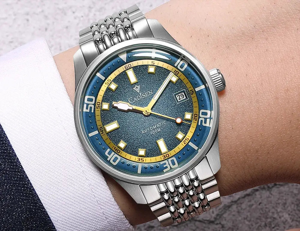 CADISEN automatic men's stainless steel watch with blue dial, gold-tone bezel, date window, domed glass.