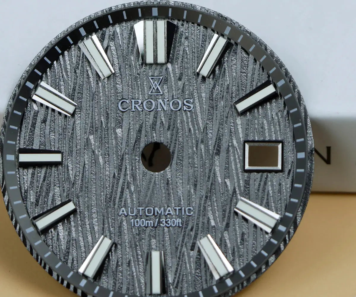 Cronos men’s wristwatch dial with birch-pattern texture, white hour markers, automatic movement, 100m water resistant