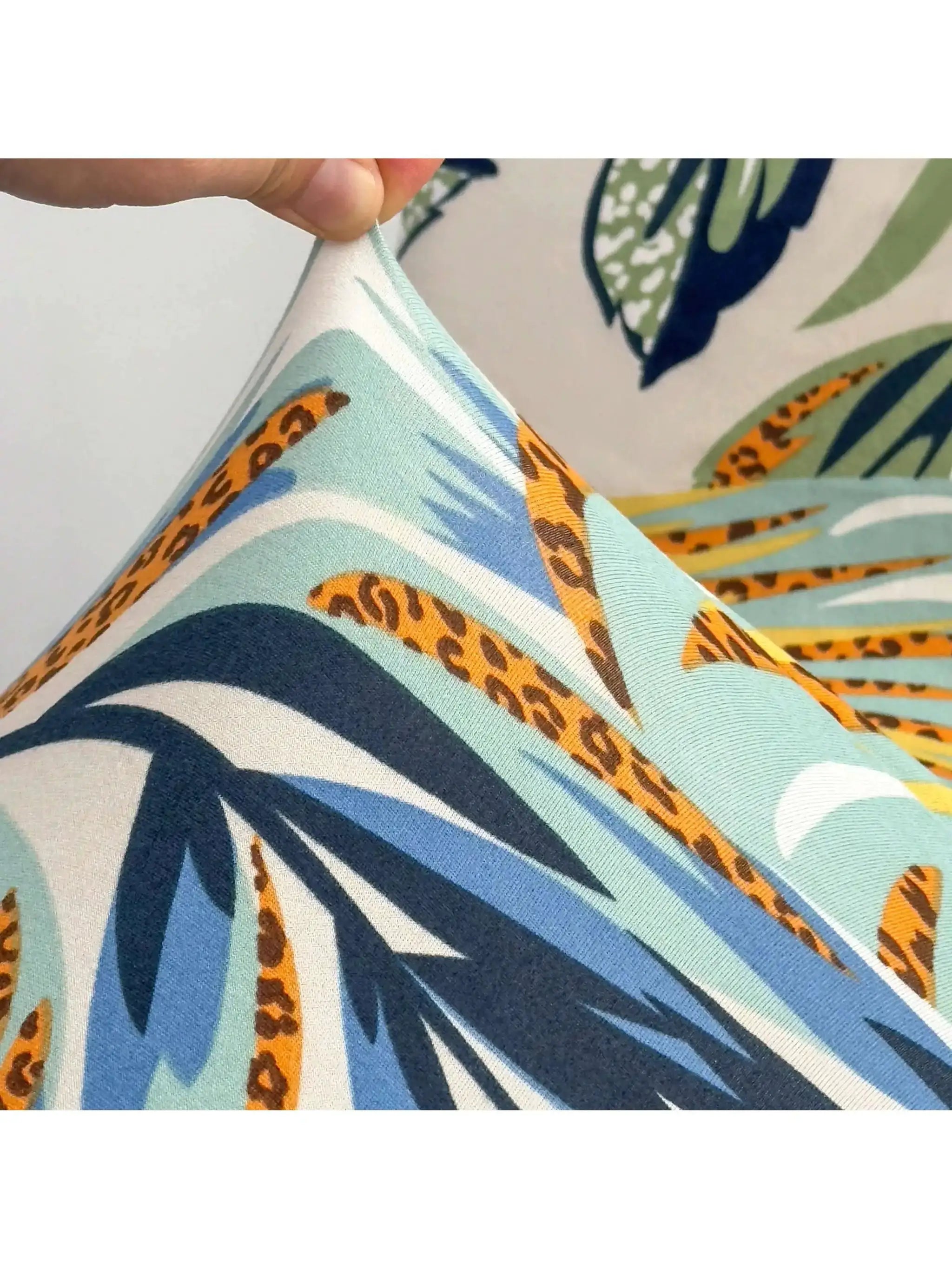 Outdoor tropical print cushion cover; turquoise palm leaf pattern with orange accents by Simples Market