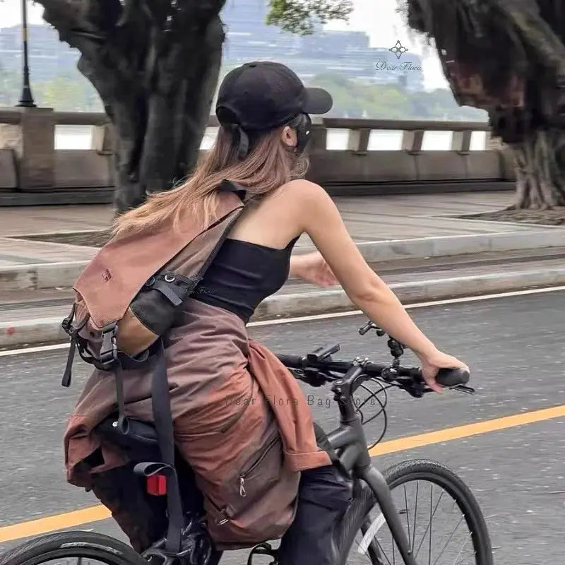 Simples Market Y2K portable light nylon crossbody bag in brown worn by cyclist on a bike