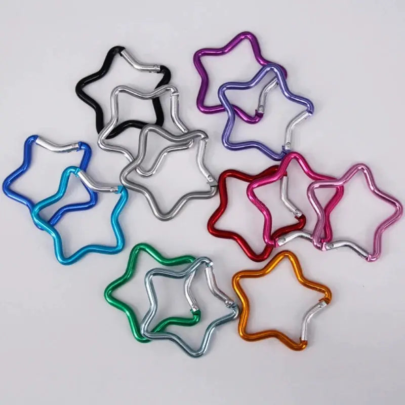 Aluminum alloy star-shaped spring locking carabiner keychains in assorted colors by Simples Market.