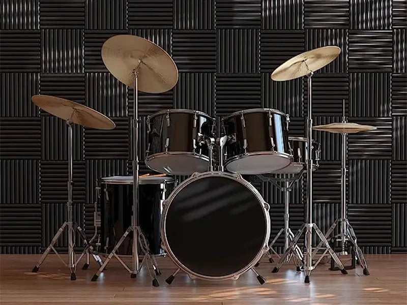 TOUO acoustic foam panels; black soundproofing wall tiles behind a drum kit in a studio