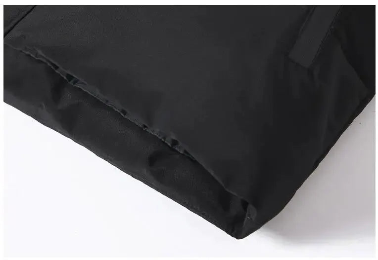 Men's black puffer jacket shown in close-up of the sleeve hem