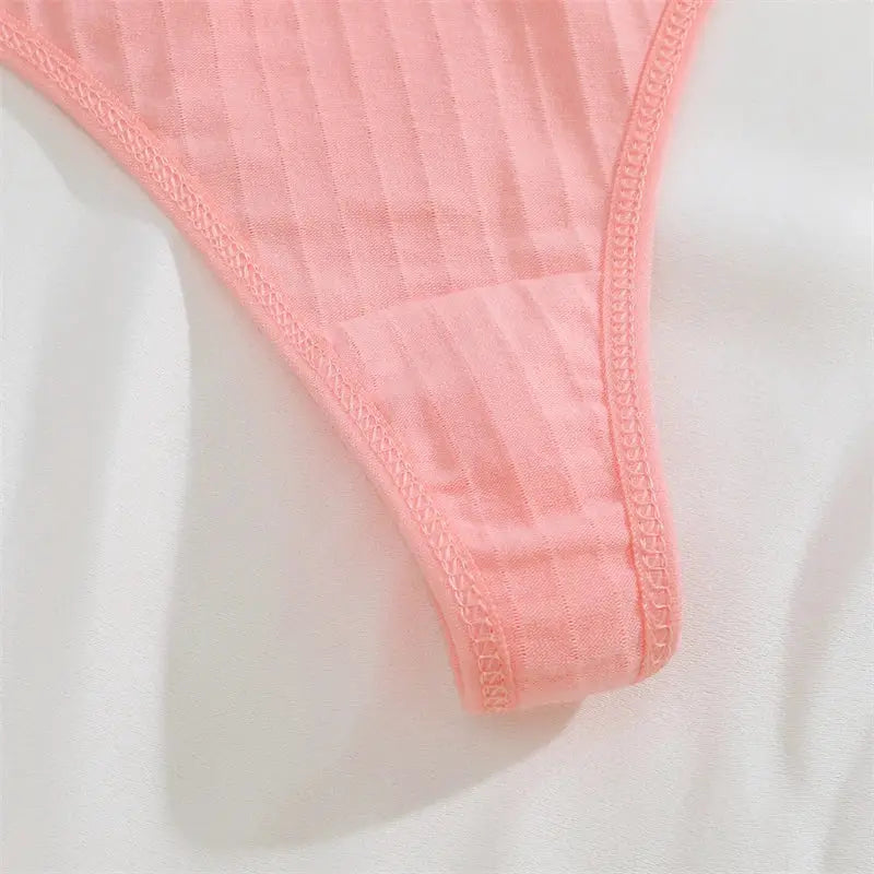 Pink ribbed cotton thong underwear with low-rise, T-back style.