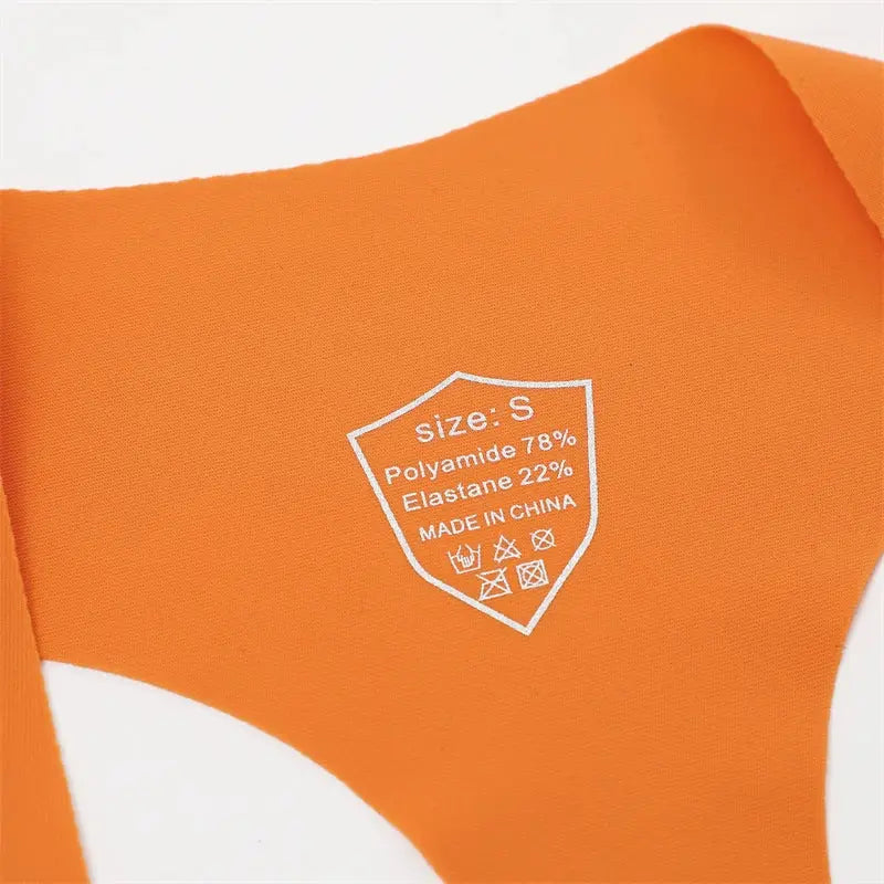 Orange seamless women’s underpants fabric close-up with size S label and 78% polyamide 22% elastane