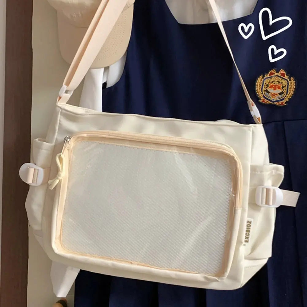 Women Ita bag shoulder bag with clear window front pocket, cream color, adjustable strap, multiple pockets.