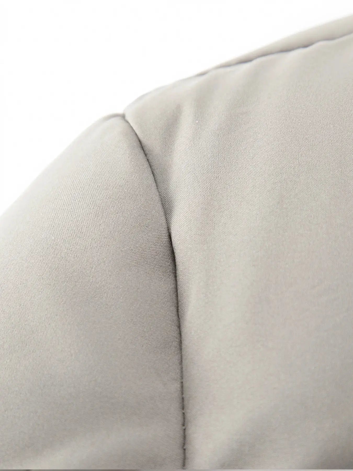 Men's cotton jacket in beige, close-up of shoulder seam on smooth fabric