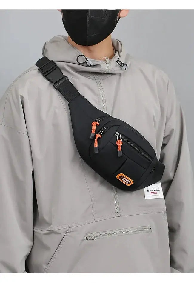 Simples Market Oxford waterproof waist bag; black nylon fanny pack with orange zipper pulls, worn crossbody.