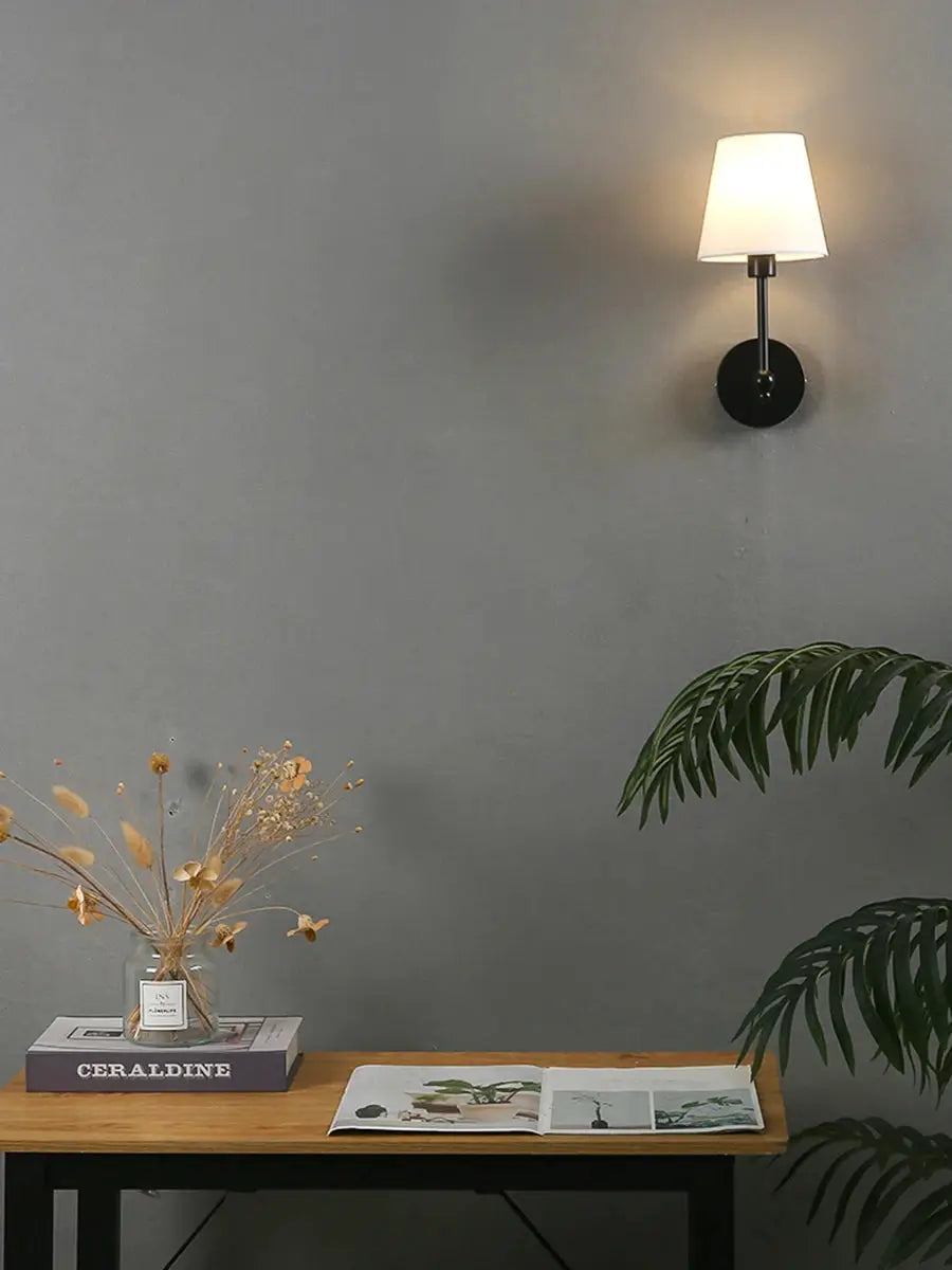 American Retro wall lamp by Simples Market; black metal sconce with white fabric shade.