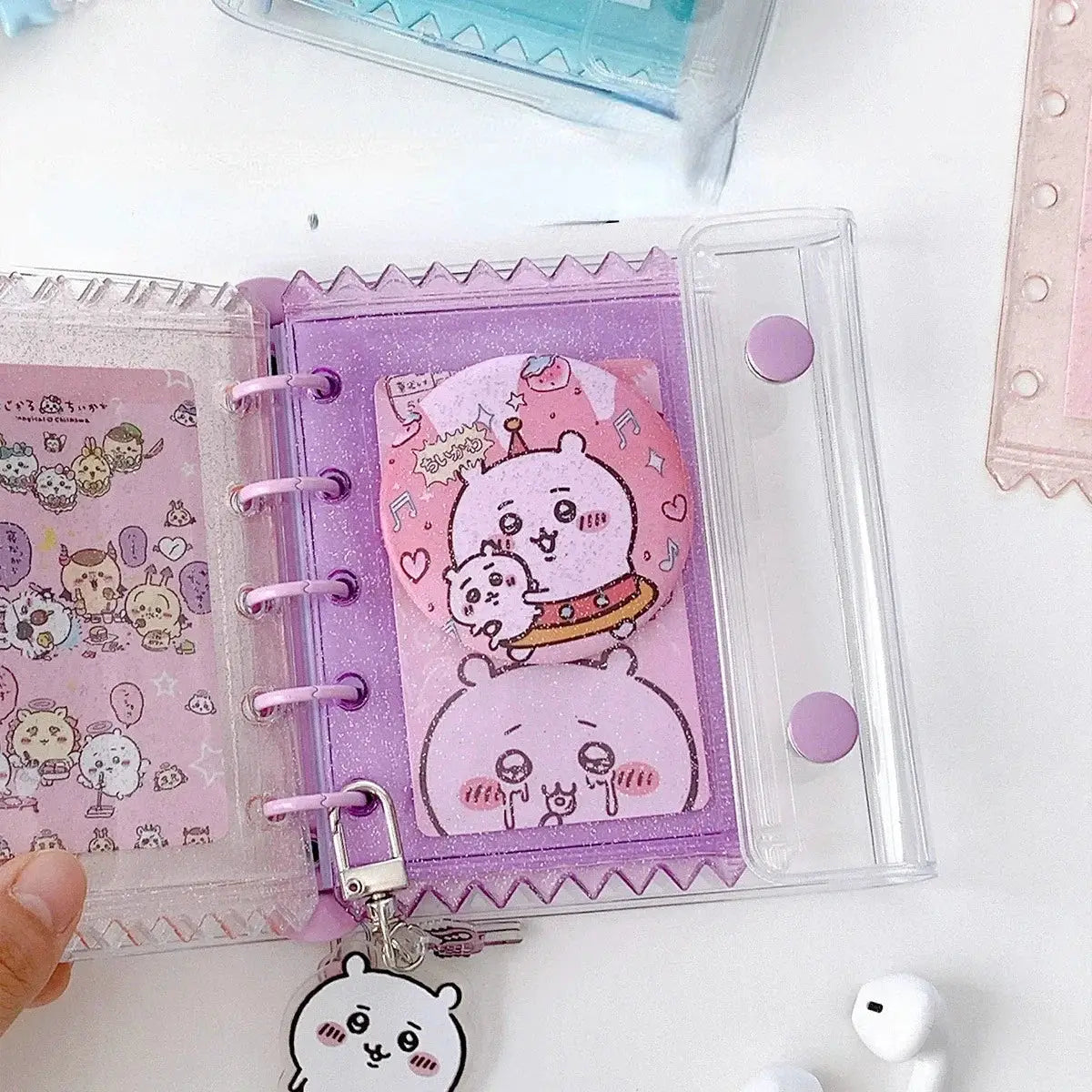 Purple glitter PVC binder with 5-ring spine and clear zipper pocket, featuring pastel animal art.
