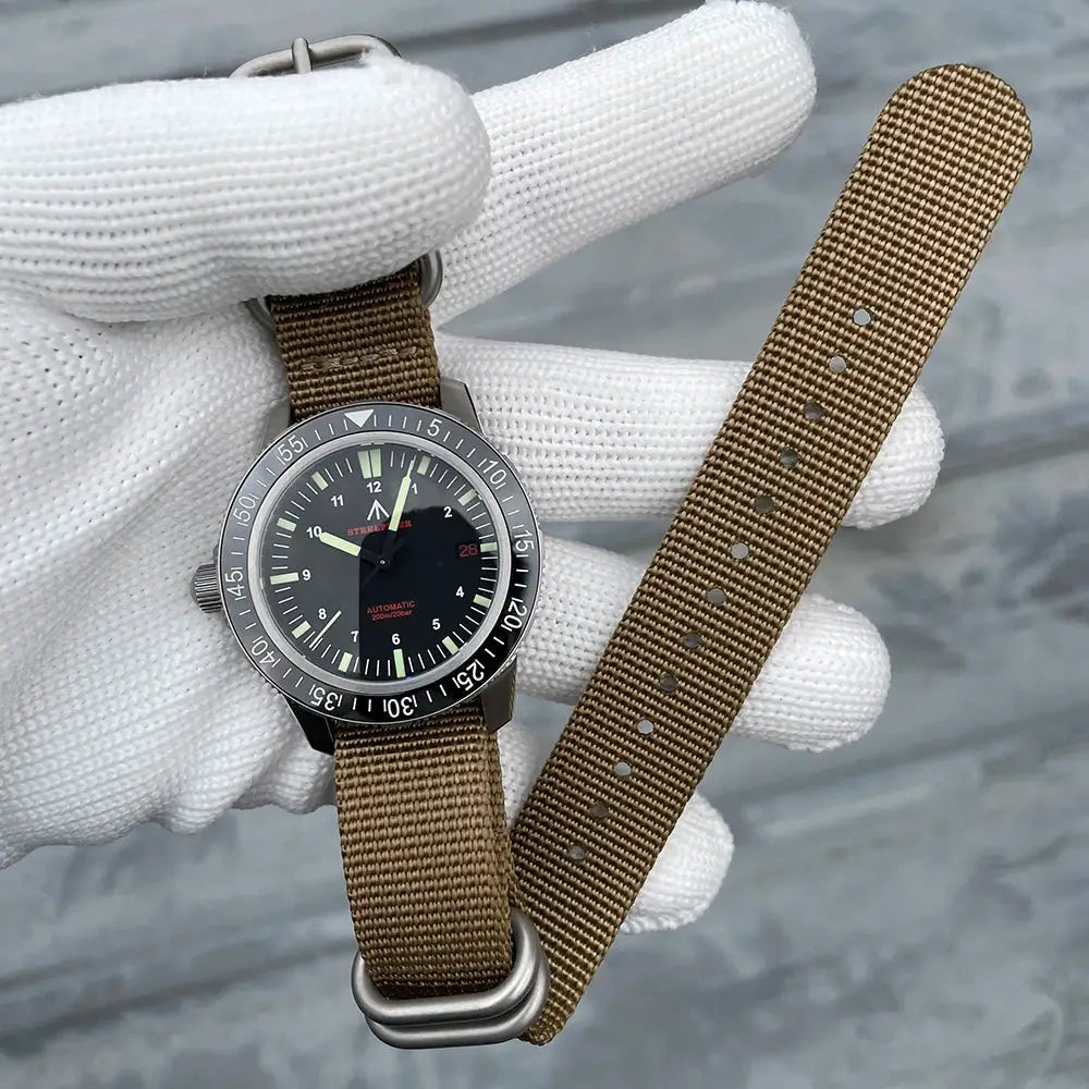 STEELFLIER SF783 dive watch with black dial, ceramic bezel, luminous markers, and two brown nylon straps.