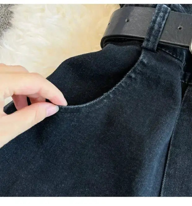 Denim romper close-up: dark blue wide-leg jumpsuit with pocket and belt-loop detail