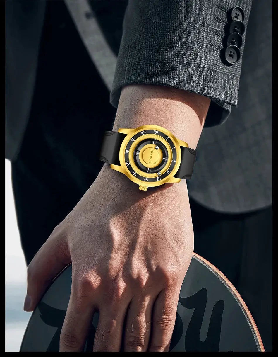 FOXBOX watch by Simples Market, gold-tone case with black strap on a man's wrist.