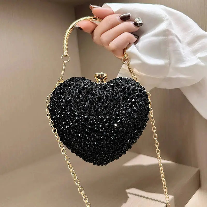 Black heart-shaped crystal clutch purse with gold chain handle for evening events