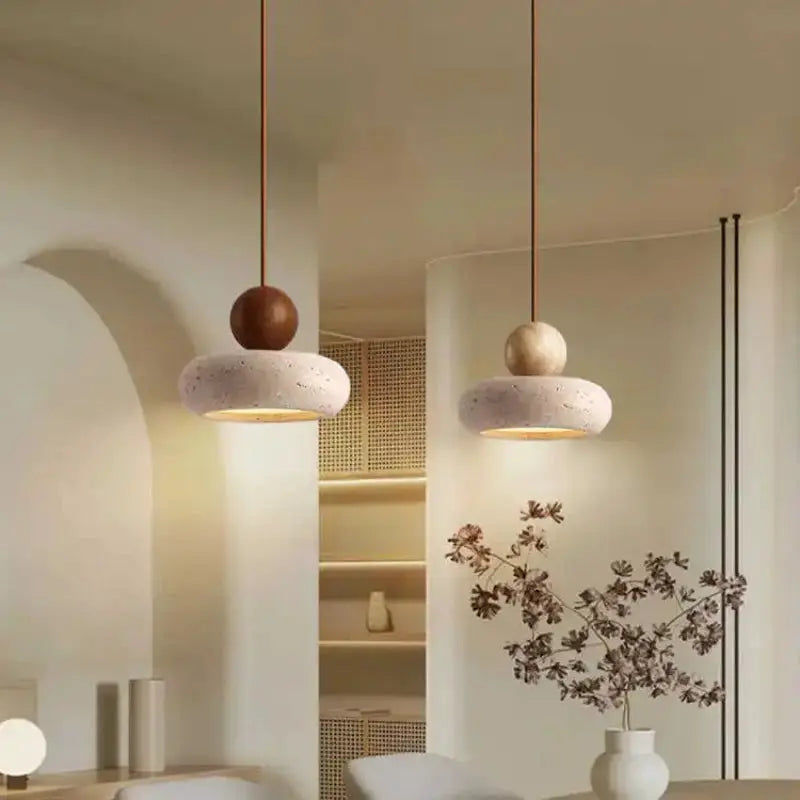 Vintage pendant light with natural yellow agate stone and speckled donut shade, two hanging fixtures with warm glow.