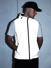 White hooded vest with black zipper worn by man in a light gray short-sleeve tee