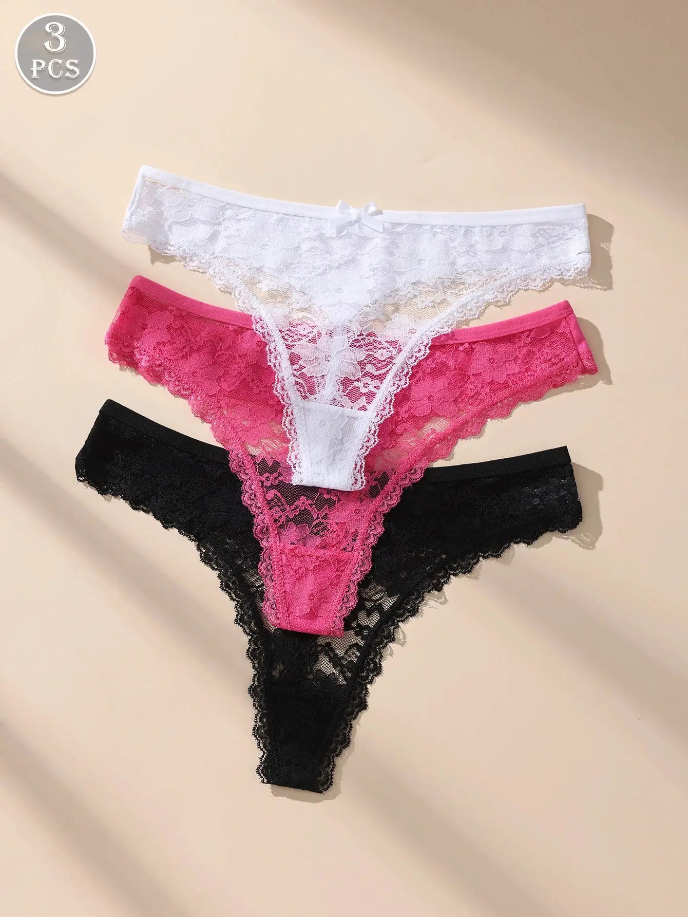 Three-piece women's lace bow low-waist underwear set in white, pink, and black; breathable lightweight lace briefs.