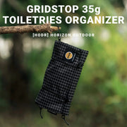 HODRGEAR ultralight toiletries organizer, black UHMWPE gridstop roll-up pouch with YKK zippers, hanging from a branch
