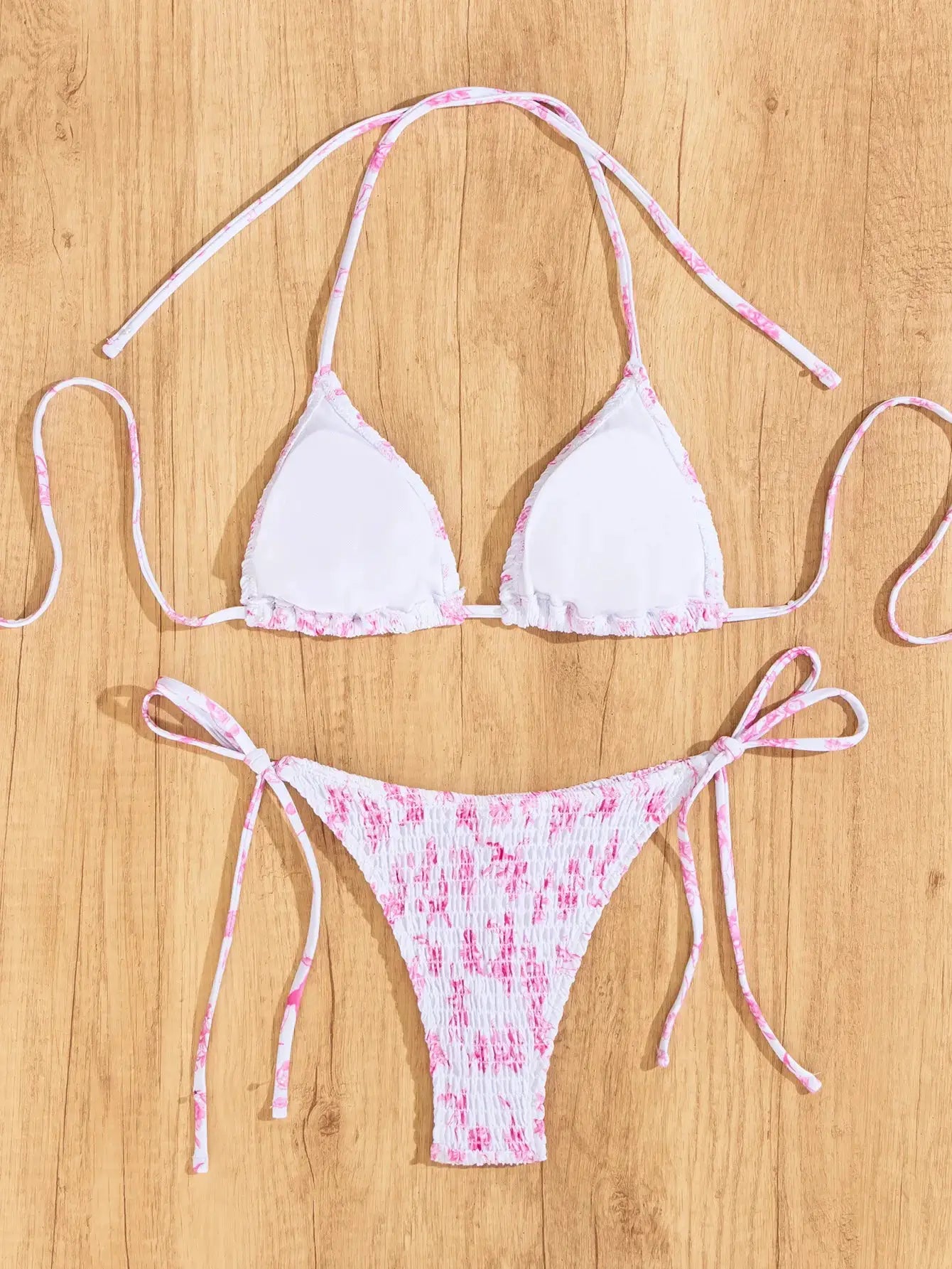 Triangle bikini set with white cups and pink floral trim, matching pink-printed Brazilian bottoms