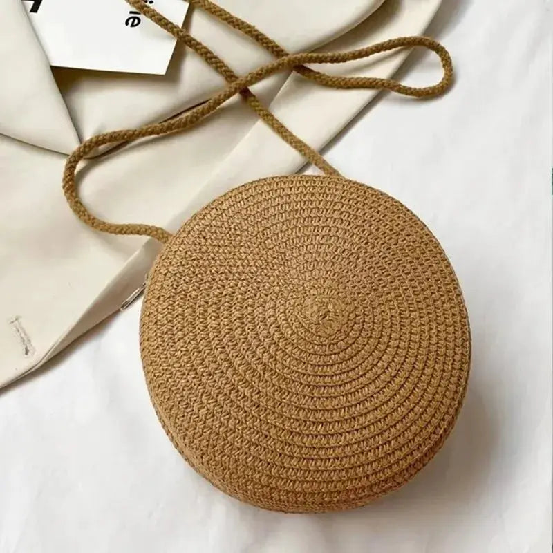 Simples Market round straw crossbody bag; natural beige woven circular handbag with long strap