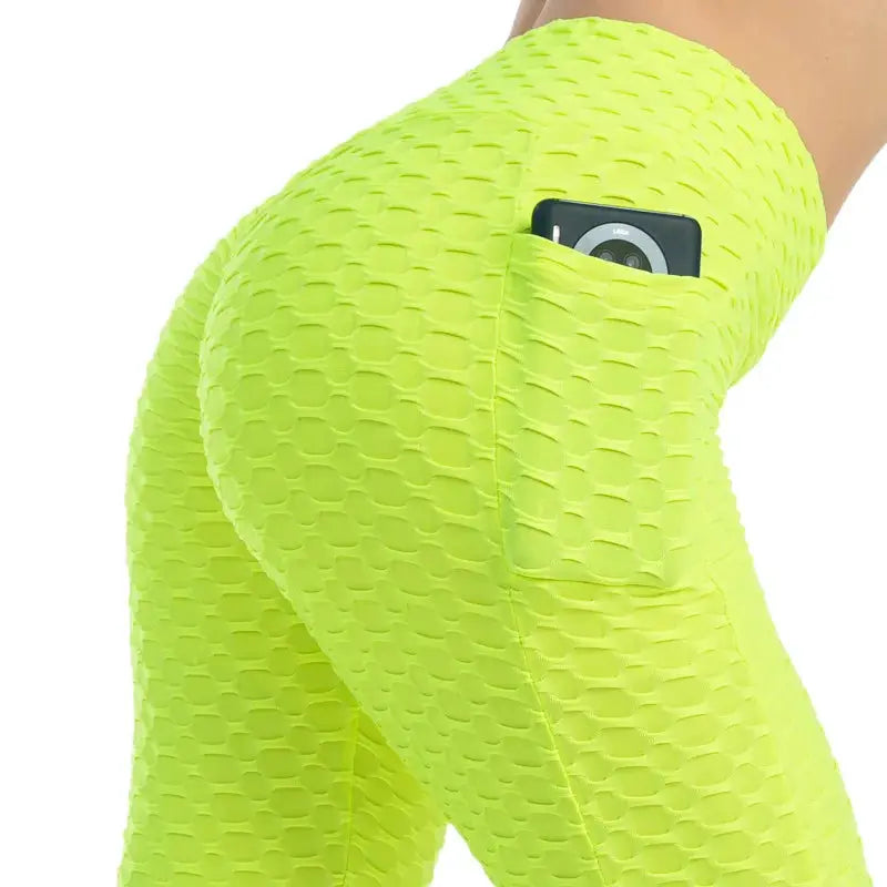 Women's neon yellow bubble-textured leggings with a side phone pocket, high-waist stretchy fitness pants