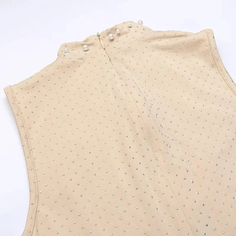 Beaded mesh jumpsuit by Simples Market in apricot; sleeveless O-neck one-piece.