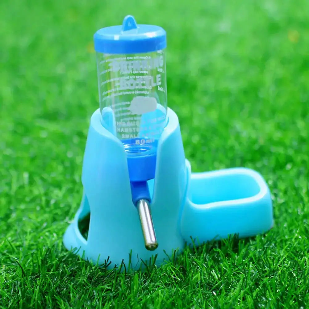 Hamster automatic water dispenser by Simples Market with blue bottle and blue base on grass