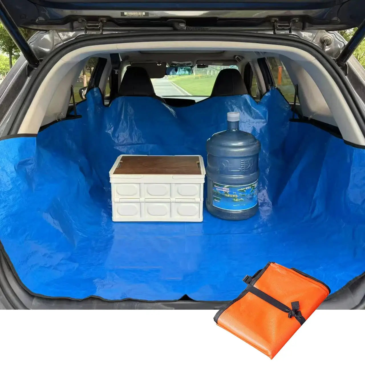 Universal car trunk mat in blue, waterproof cargo liner protecting a car trunk with a water jug and plastic storage box.