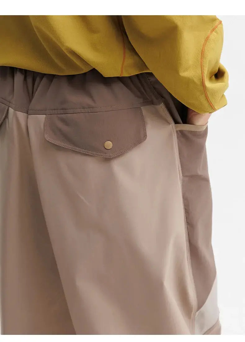 Men's outdoor cargo pants by Simples Market in beige with flap pocket, elastic waist, and wide-leg silhouette