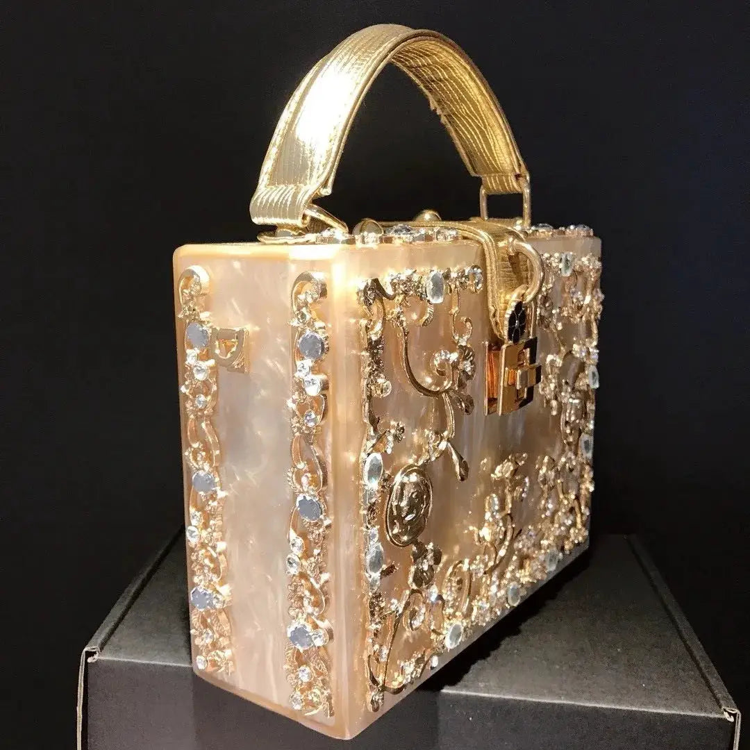Crystal evening bag by Simples Market; gold-toned box clutch with crystal floral metalwork.