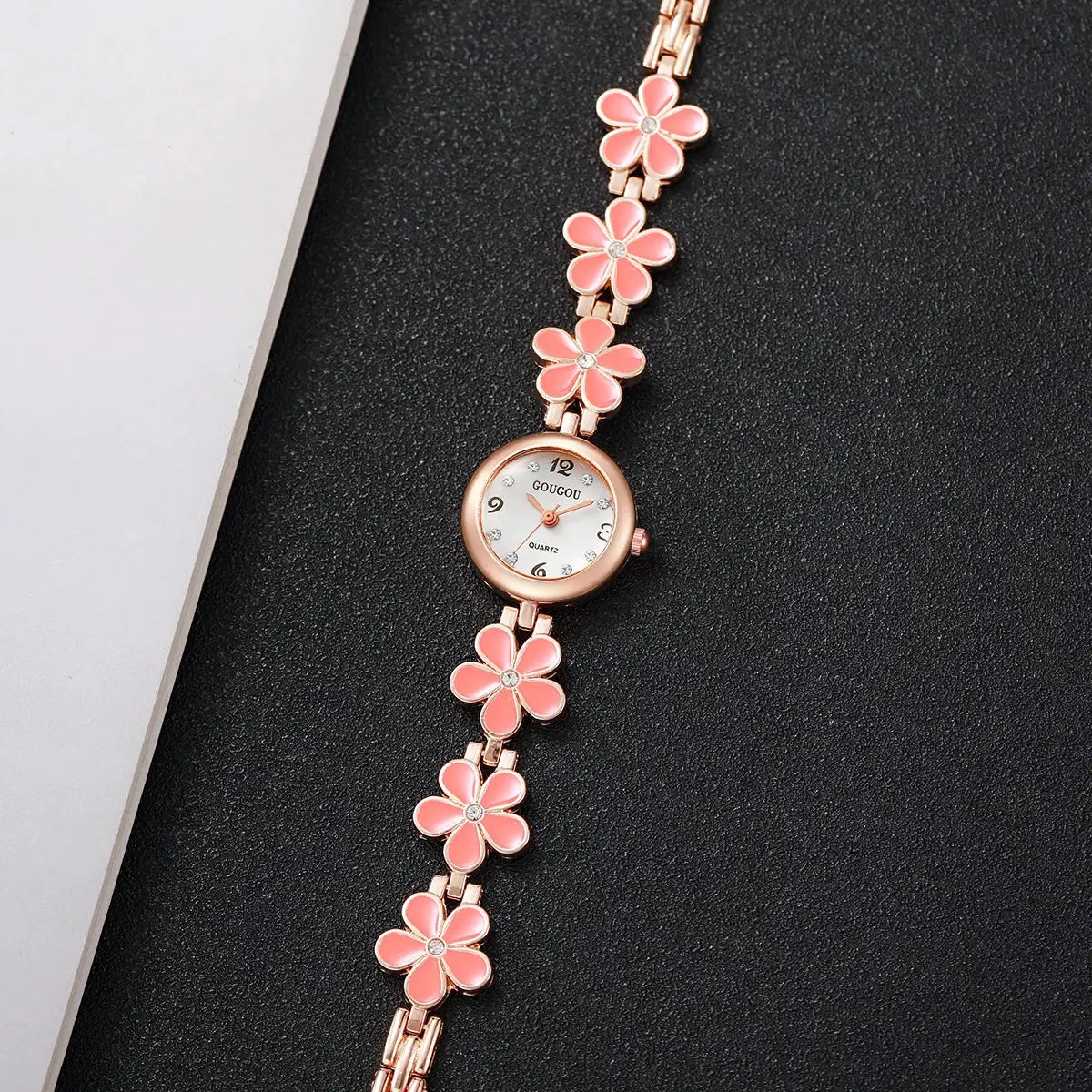 Women's rose-gold watch by Simples Market with pink enamel flower bracelet links and crystal hour markers.