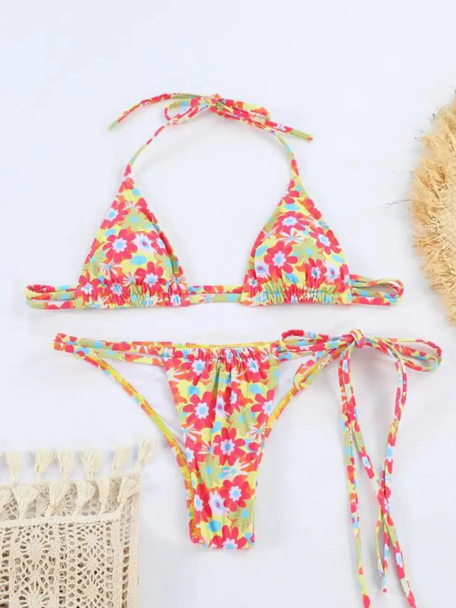 Women's floral bikini set with triangle top and tie-side bottoms in yellow with red, pink and blue flowers