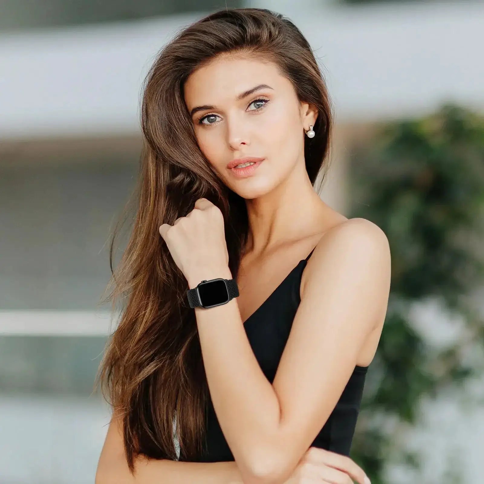 Braided black Apple Watch band with woven strap on a model's wrist; compatible with various Apple Watch sizes