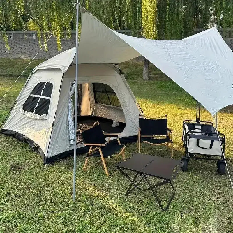 Simples Market folding stainless steel camping table at a tent campsite with folding chairs and a shade canopy