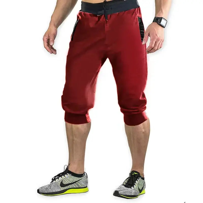 Simples Market men's sports pants, red knee-length joggers with black waistband, zip pockets and elastic cuffs