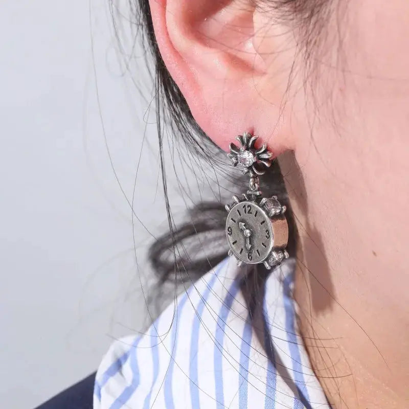 Clock earrings by Simples Market; vintage silver-tone with flower accents and hanging mini clock dial.