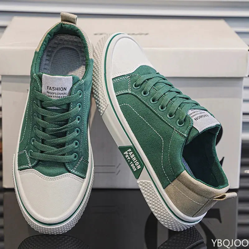 Pair of men's lightweight canvas sneakers by Simples Market, green with white toe cap and sole.