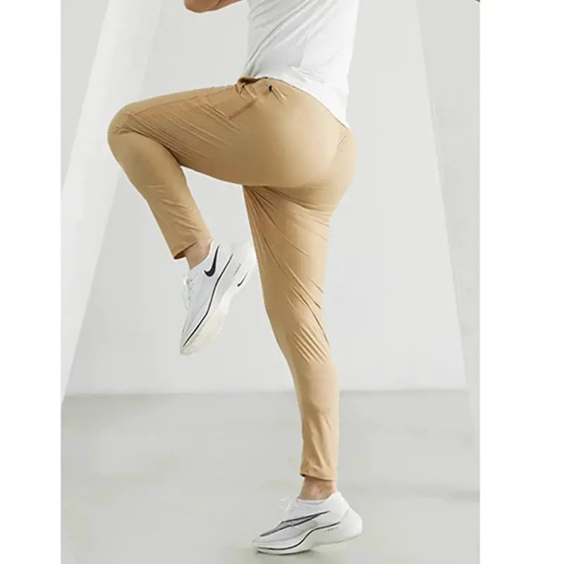 Men's running pants, tan slim-fit with elastic waistband