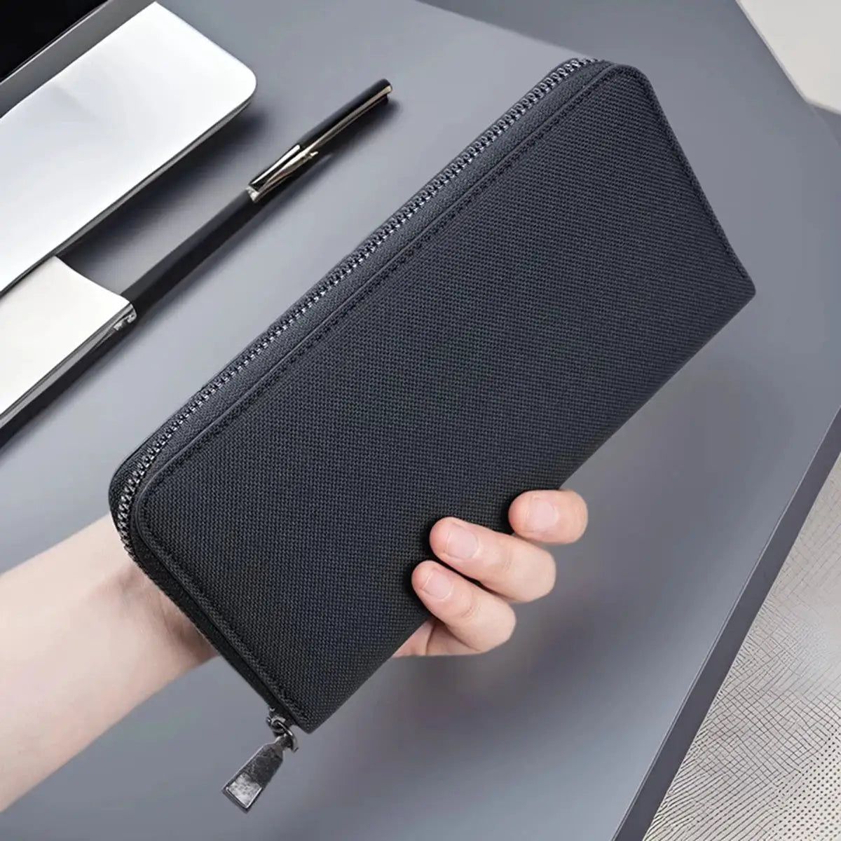 Men's long zippered wallet in black canvas with large capacity and multiple card slots.