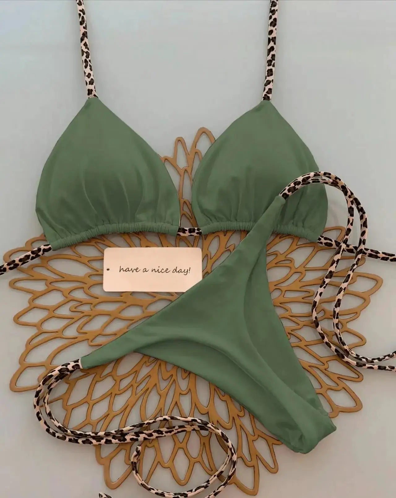 2-piece bikini set: green triangle-top with leopard-print straps and matching bottoms.