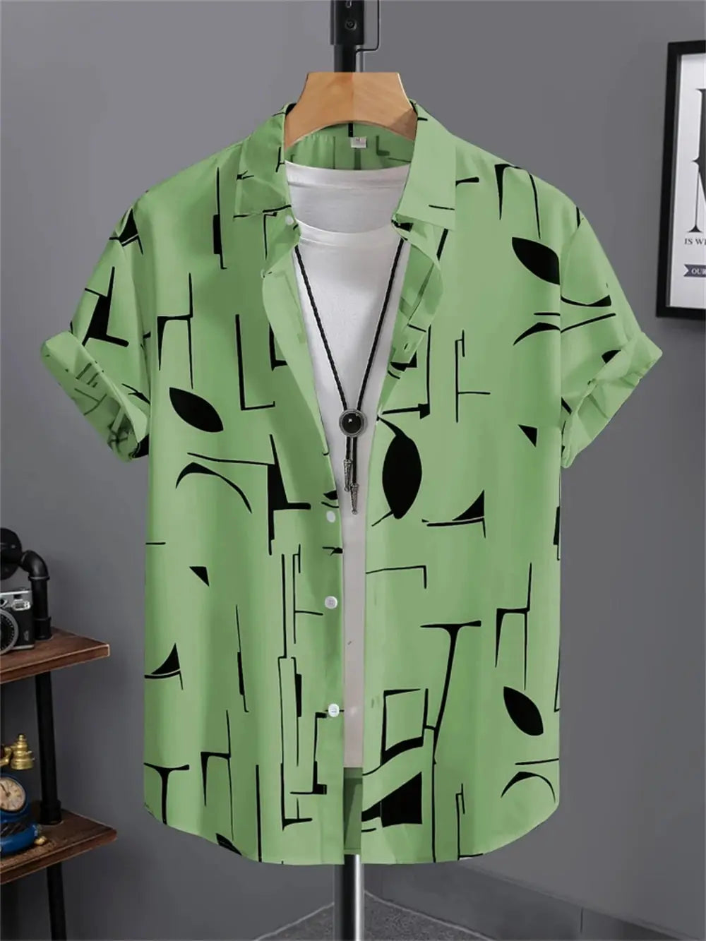 Men's green short-sleeve shirt with a black abstract geometric print