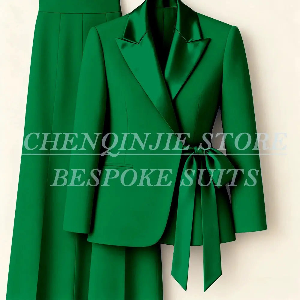 Women's green blazer suit set from Simples Market with peak lapels and waist-tie belt, matching pants.