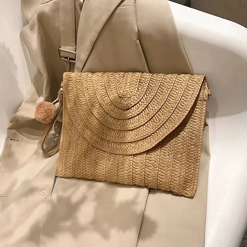 Handmade straw envelope crossbody bag in natural beige with pom-pom charm