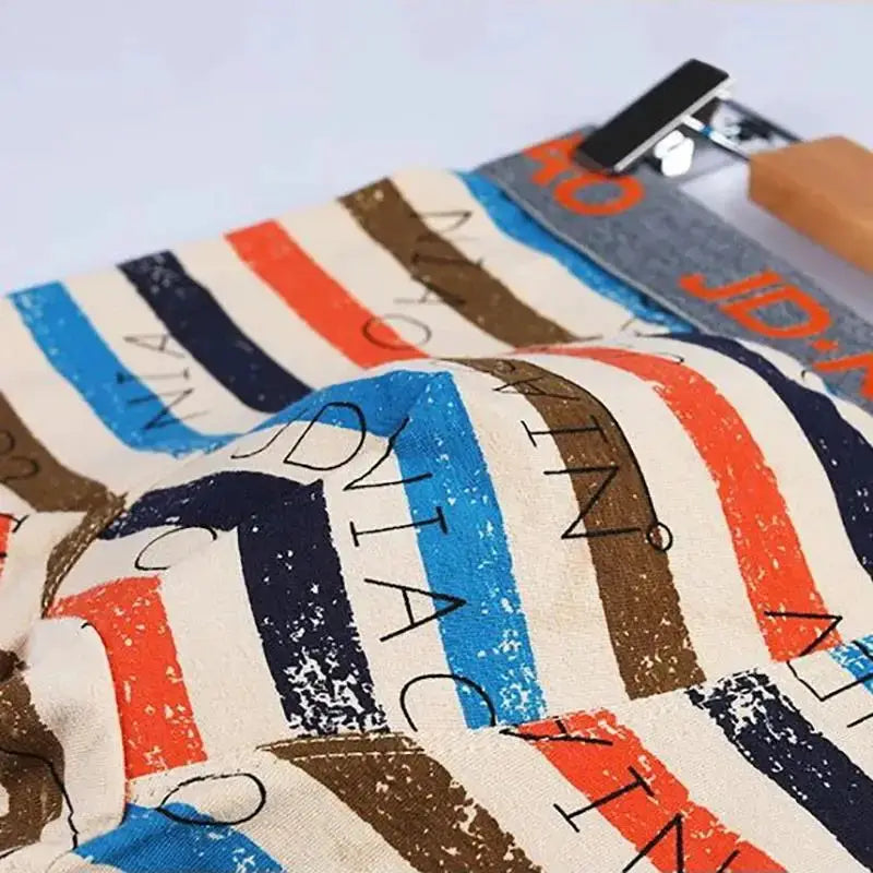 Boxer shorts by Simples Market; multicolor striped cotton fabric close-up