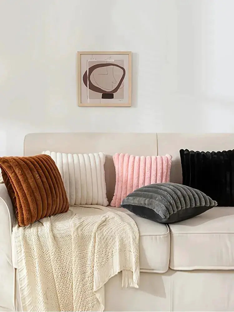 5 stripe corduroy pillow covers in brown, white, pink, gray, and black on a white sofa